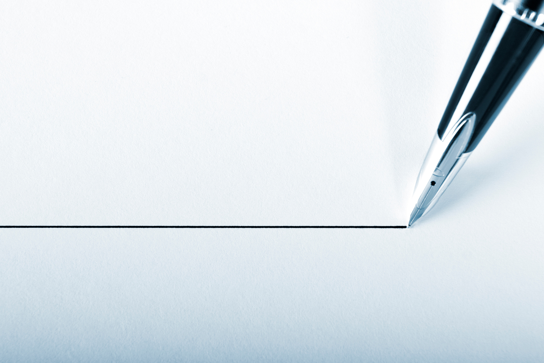 A pen drawing a precision point line on white paper